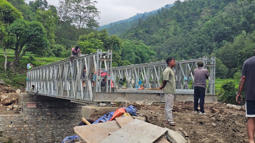 Side view of galvanized bailey bridge truss panels on the abutment during installation at Khungri, Rolpa, Nepal by Inter Tech Pvt. Ltd.