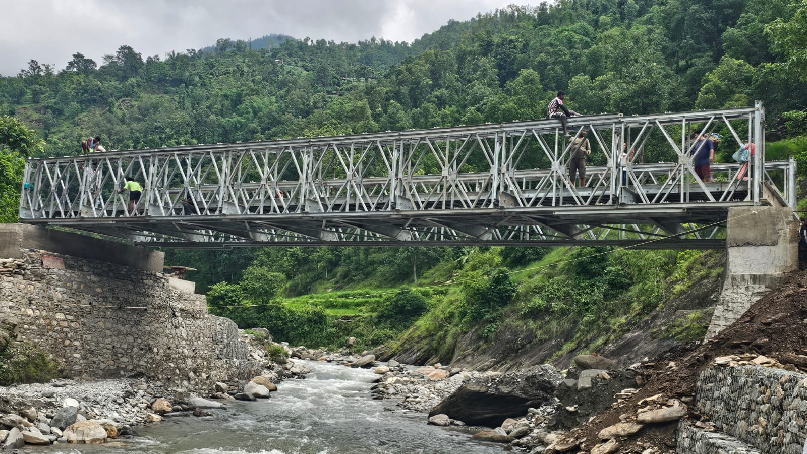 Completed 24 metre galvanized steel bailey bridge over a river at Khungri, Rolpa, Nepal, fabricated and installed by Inter Tech Pvt. Ltd., Butwal
